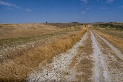 Winding Dirt Path through Dry Hills and Scenic Valley Stock Photos