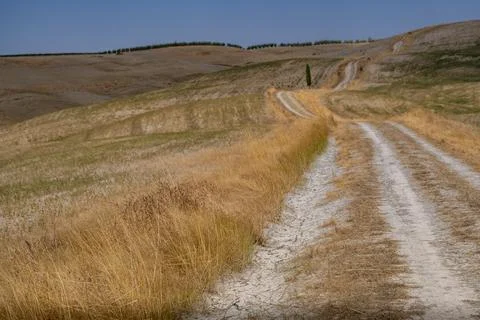 Winding Dirt Path through Dry Hills and Scenic Valley Stock Photos