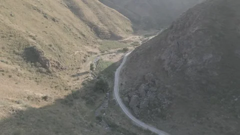 Winding Dirt Road and River Valley in Kastek Gorge, Kazakhstan Stock Footage 342749731