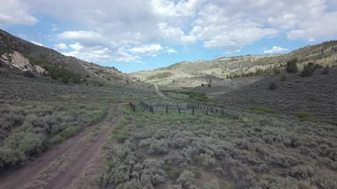 Winding Dirt Road through Green Uinta Mountain Foothills Utah Stock Footage 338305230