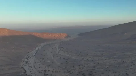 Winding Dry Riverbed Through Desert Valley at Dawn Stock Footage 336025350