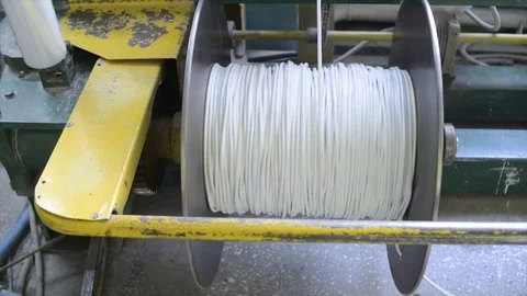 Winding the electric cable on the bobbin packaging Stock Footage 127829918