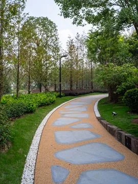 Winding garden path with stone stepping stones in forest - Serenity concept Stock Photos