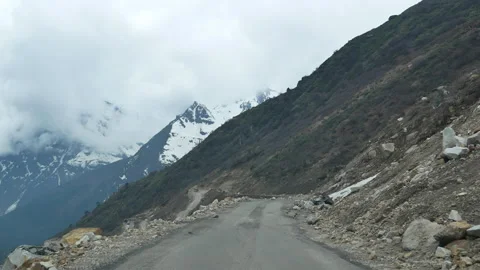 Winding high altitude road through snow Himalaya Vídeos de archivo 346140937