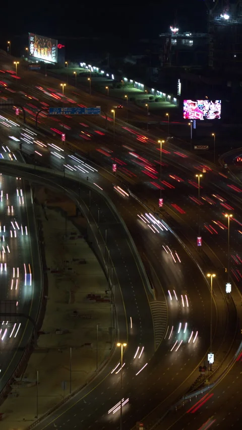 Winding highway traffic light trails at night in Dubai, UAE Stock Footage 341775421