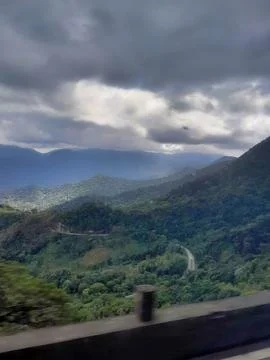 Winding Mountain Highway View Under Dramatic Overcast Sky Stock Photos