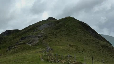 Winding Mountain Path Leading Up a Green Slope Under Cloudy Sky in Koenigsl.. Video stock 326052121