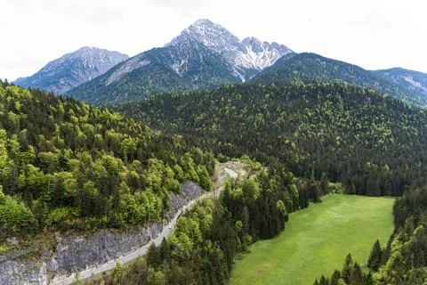 Winding Mountain Path through Green Valley Stock Photos