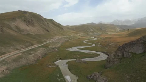 Winding mountain river flowing through the Kok Kiya Valley in Kyrgyzstan 스톡 동영상 346879148