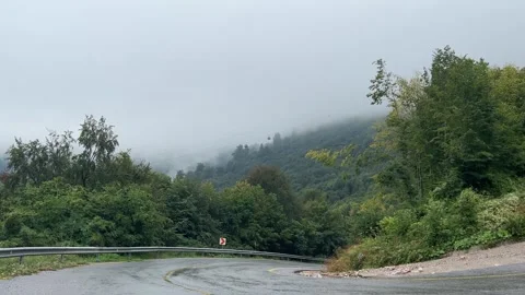 Winding Mountain Road Below Cable Cars in Misty Kartepe Forest Stock Footage 344559733