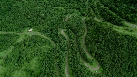 Winding mountain road between dense forest near Gnevank Monastery. Lori Armenia. Stock Footage 253418092