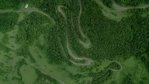 Winding mountain road between dense green forest in Lori Armenia. Video stock 253419138