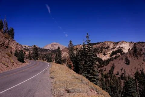 Winding Mountain Road with Bright Blue Sky Stock Photos