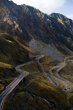 Winding Mountain Road in a Dramatic Alpine Landscape Stock Photos