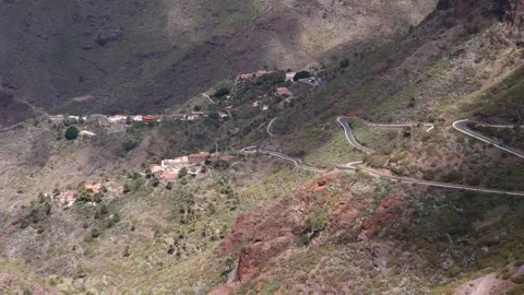 A winding mountain road leads to the remote village of Masca in Tenerife Stock Footage 318032850