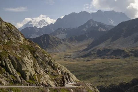 Winding mountain road passing through a valley Stock Photos