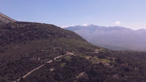 Winding Mountain Road With Snow Capped Peaks in Greece Stock Footage 337864820