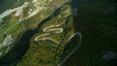 Winding Mountain Road Surrounded by Lush Green Forests Video stock 323271197