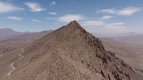 Winding mountain road through barren desert terrain Stock Footage 292830112