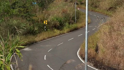 Winding Mountain Road Through Grassy Hillside Stock Footage 329839713