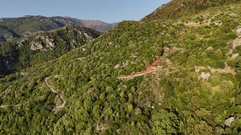 Winding mountain road through green hills aerial view Stock-Footage 333299423