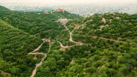 Winding mountain road through lush green hills with fort aerial view Video stock 343812775