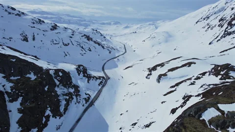 Winding Mountain Road Through Snow-Covered Alpine Valley Stock Footage 336112497