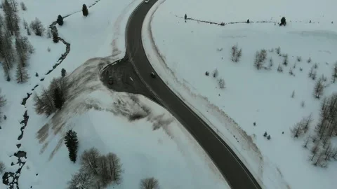 Winding mountain road through snowy alpine landscape Stock Footage 341607804