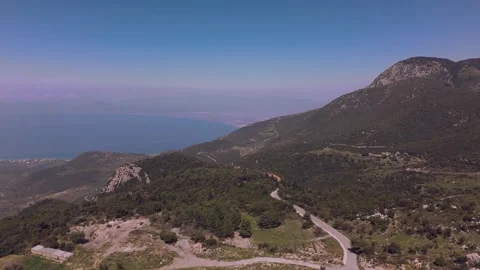 Winding Mountain Road Toward Snow Capped Peaks in Greece Stock Footage 337864982