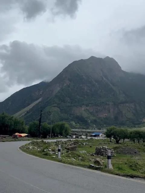 Winding Mountain Road Under Dramatic Overcast Sky Video stock 341629856