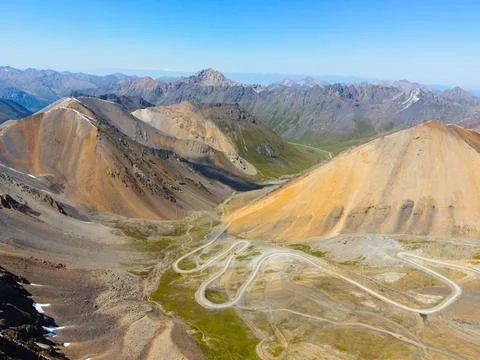 Winding mountain switchback road through high mountain pass Stock Photos