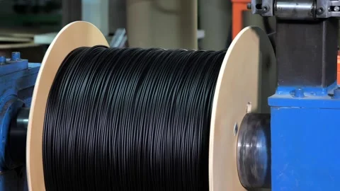 Winding of the optical cable to the bobbin in the production line Stock Footage 247576920