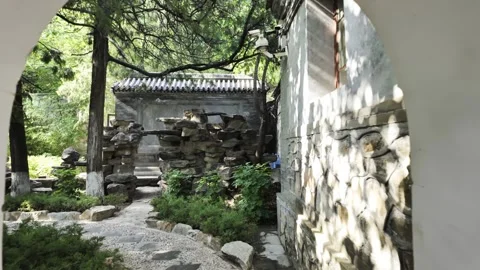 A Winding Path Leading to Seclusion: Passing Two Stone Gates to a New Space Stock Footage 317474582