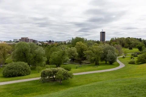 Winding path through green spring city park in Ottawa, Canada. Stock Photos