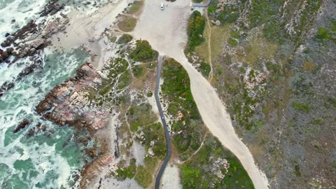 Winding Paths Through Low Shrubbery And Grassland Approach Rocky Shoreline And Vidéo 339769831