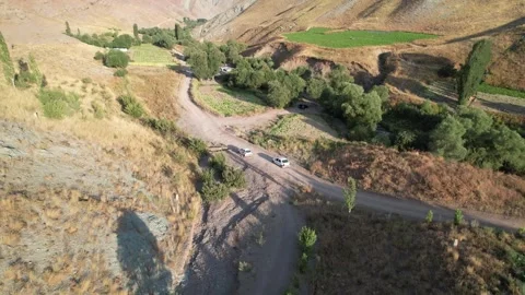 Winding paved Chalus Road threads trees and terraced fields on a mountain Stock Footage 343907717