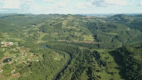A winding river among crop fields and forests. Drone footage. Video stock 332260737