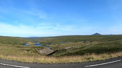 Winding river and scenic mountain landscape from moving car in Iceland Stock Footage 333445765