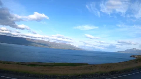 Winding river and scenic mountain landscape from moving car in Iceland Stock Footage 333461380