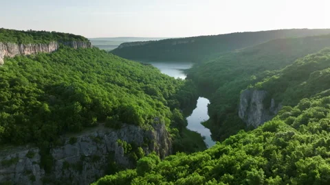 Winding river cutting through forested cliffs at sunset – Emen Canyon aerial Stock Footage 305230039