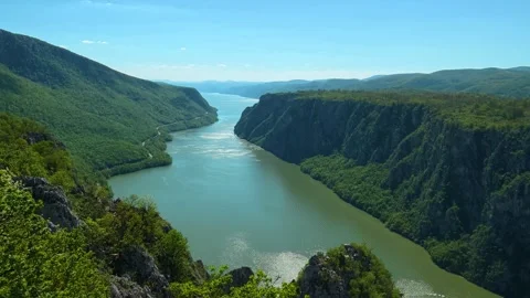 Winding river flows between steep, forested cliffs. Balkan, Eastern Europe, POV Video stock 333349226