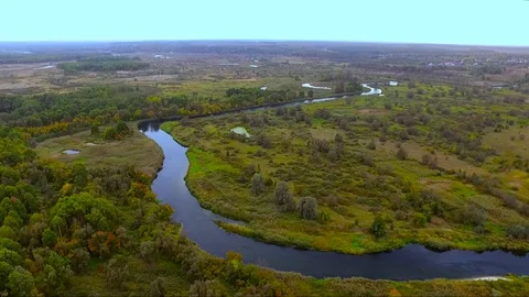 A winding river in a green forest Stock Footage 128658769