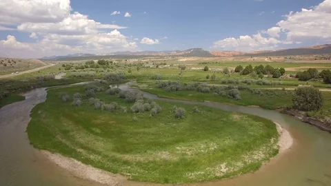 Winding River in Meadow Aerial Shot of Grasslands Stock Footage