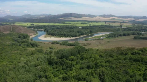 A winding river in a mountainous area Видео 232400779