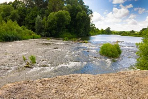 Winding river in a summer forest in cloudy weather with rain clouds. Landscap Stock Photos