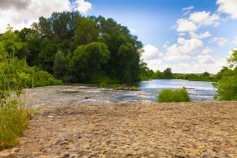 Winding river in a summer forest in cloudy weather with rain clouds. Landscap Stock Photos