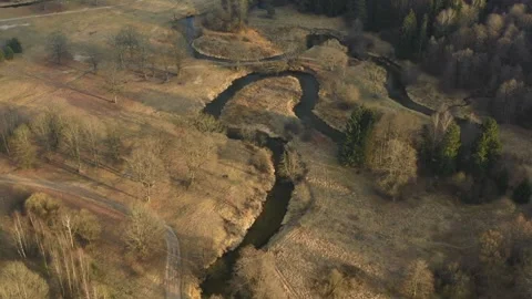 Winding river through autumn field and forest aerial view Video stock 333874932