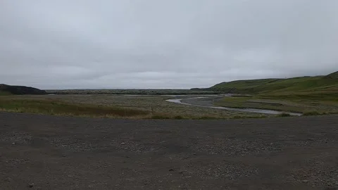 Winding river through mossy lava fields and green hills in Iceland Stock Footage 334293217