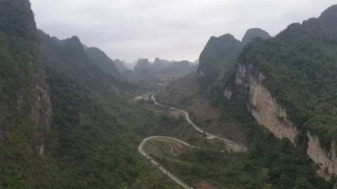 Winding Road Between Two Giant Mountains in Vietnam Aerial Drone Video Stock Footage 124353947