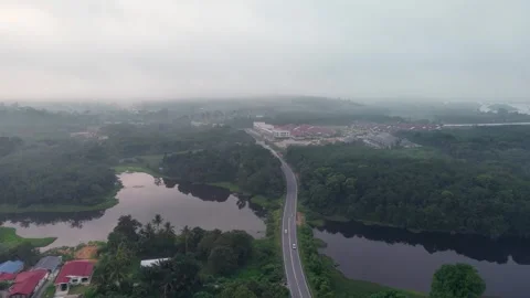 Winding road cuts through misty landscape Video stock 339858065